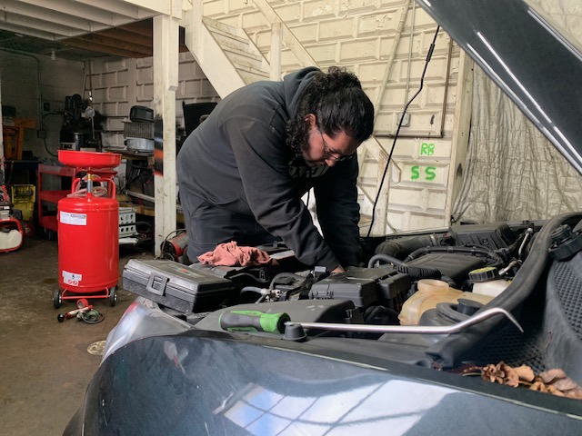 Sebastian Sanchez working on a vehicle